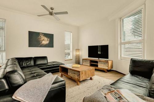 a living room with a couch and a flat screen tv at Waves 203 on Currumbin in Gold Coast