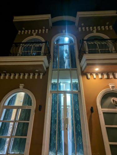 a building with a glass tower and two windows at Executive Oasis in Mūsapur