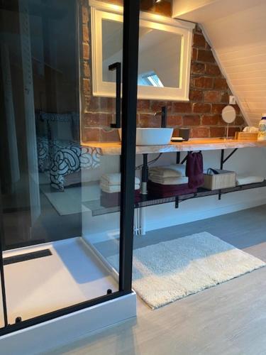 a bathroom with a sink and a mirror at Le 18 Pontcel in Luzarches
