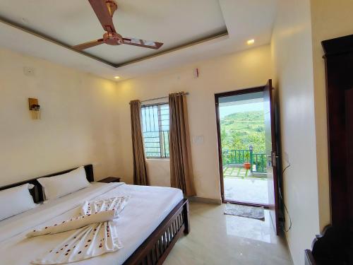 a bedroom with a bed and a large window at The Autumn by Maat Hotels in Vagamon