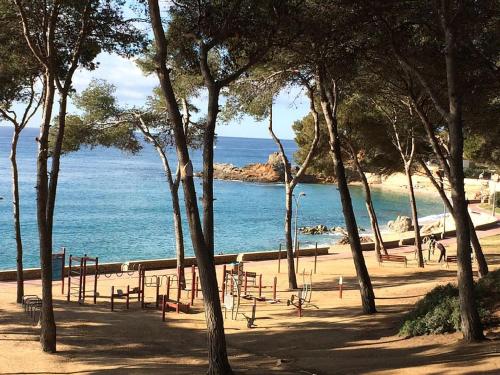 a park with a playground next to the water at Estudio Paz in Lloret de Mar