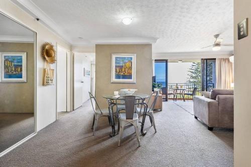a living room with a table and a couch at Ocean Breeze at Palm Beach in Gold Coast