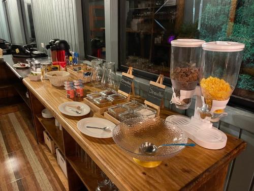 a buffet with a counter with food on it at Hotel Bután Coronel in Coronel
