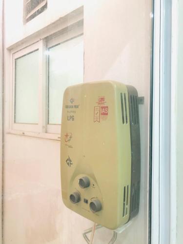 a toaster hanging on a wall next to a window at Executive Oasis in Mūsapur