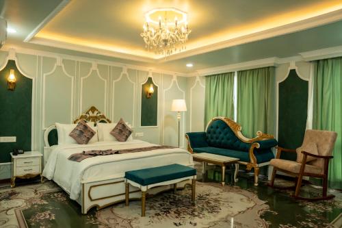 a bedroom with a king sized bed and a chair at G Ramayana in Kathmandu