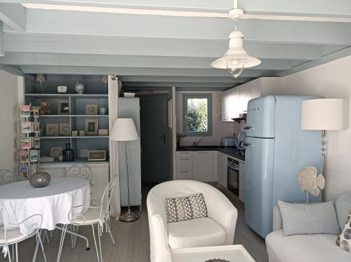 Il comprend une cuisine et un salon avec un réfrigérateur bleu. dans l'établissement Ty Malauna Jacuzzi, à La Trinité-sur-Mer