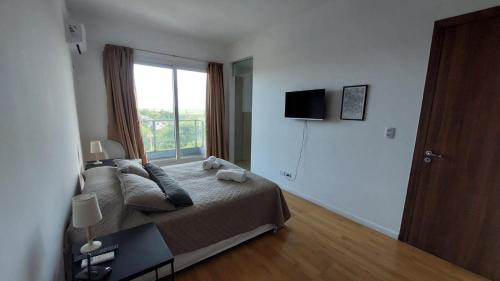 a bedroom with a large bed with a window at Tango 4C in Victoria