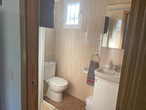 a bathroom with a toilet and a sink at Villa Vanessa in Alhaurín de la Torre