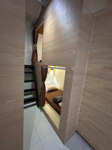 a small room with a bed in a wall at 乔治市世纪酒店 The Century Boutique Hotel George Town in George Town