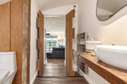 a bathroom with a sink and a mirror at Blue Horizon - Spectacular Coastal Views in Penally