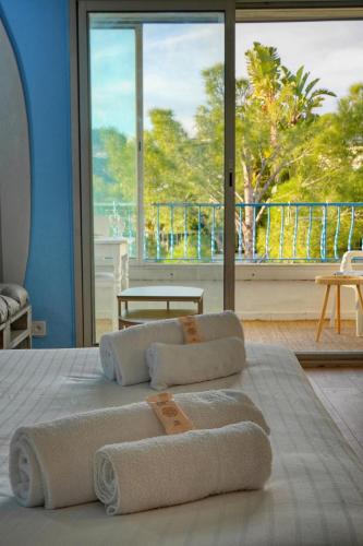 - un lit avec des serviettes et une grande fenêtre dans l'établissement Immogroom -Studio-Clim-Sea view, à Cannes