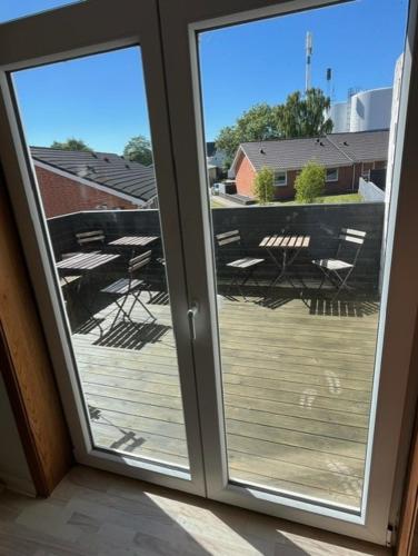 a sliding glass door with a view of a deck at Folsted - Værelse 102 med eget badeværelse og fri parkering in Bindslev