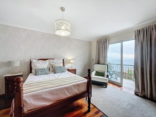 a bedroom with a bed and a balcony at Ocean View Botânico in Funchal
