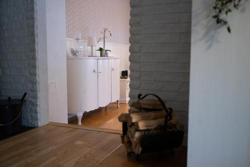a room with a white cabinet and a wooden floor at Villa Bessberget in Edsbyn