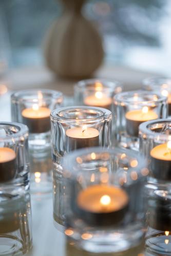 a group of votive candles in glass cups at Villa Bessberget in Edsbyn