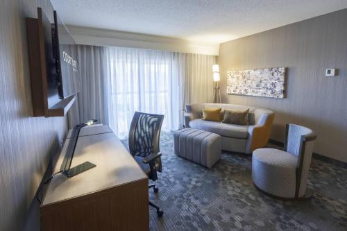 a hotel room with a couch and a living room at Courtyard by Marriott Cleveland Willoughby in Willoughby