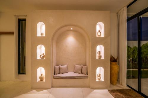 a room with a bed in a wall with lights at Villa Omnia Oasis Two Bedroom Garden Villa in Tumbak Bayuh