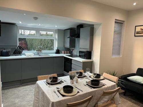 a kitchen and a dining room with a table and chairs at 3 Bedroom home, with 4 beds, parking, walk to station & town centre families and business visitors welcome in Ormskirk