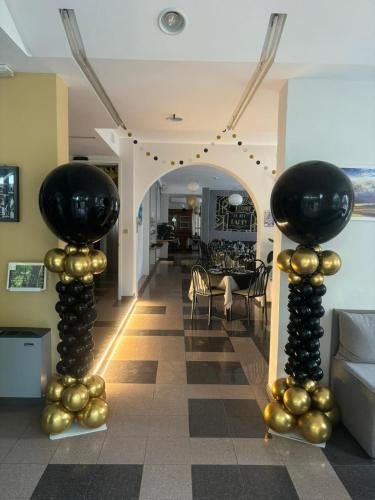 a living room with two black and gold columns at My Home Hotel in Bellaria-Igea Marina