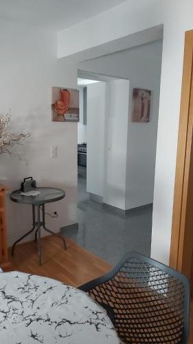 a room with a table and a chair in a room at Apartments Classic#BnM in Biograd na Moru