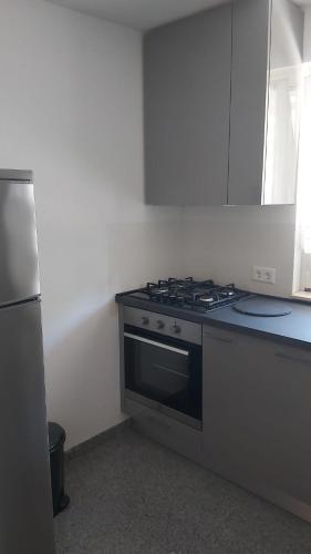 a kitchen with a stove and a refrigerator at Apartments Classic#BnM in Biograd na Moru