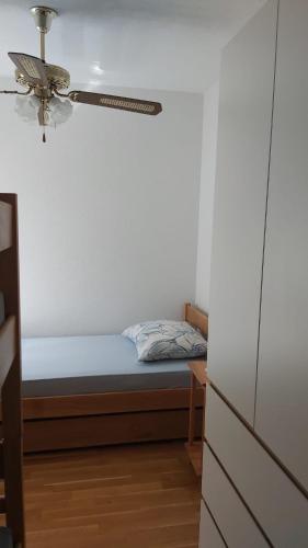 a bedroom with a bed and a ceiling fan at Apartments Classic#BnM in Biograd na Moru