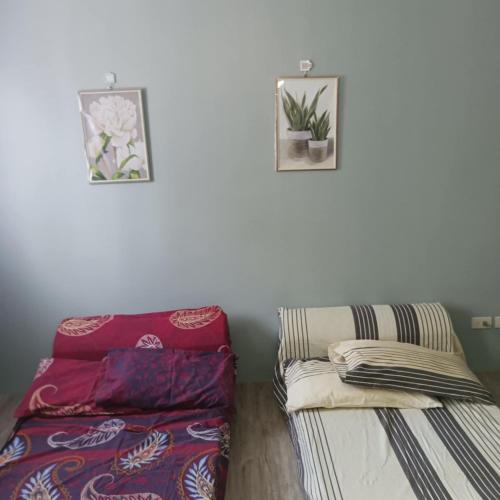 a living room with a couch and two pictures on the wall at Josephine Macatula in Santa Rosa