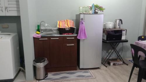 a kitchen with a refrigerator and a sink and a table at Josephine Macatula in Santa Rosa