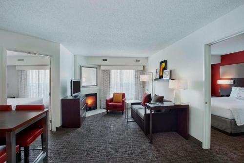a hotel room with a bed and a living room at Residence Inn Detroit / Auburn Hills in Pontiac