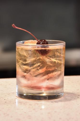 a drink with a cherry on top of a table at Courtyard Charlotte Concord in Concord