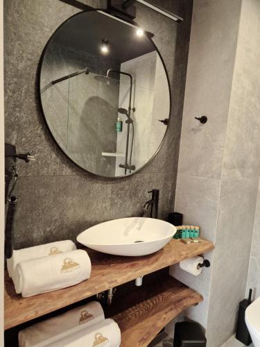 a bathroom with a sink and a large mirror at Beskidylla CHALET in Ustroń