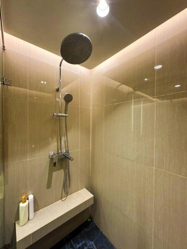 a bathroom with a shower with a shower head at Apt Embarcadero 2BR with Netflix & Pool by Damaresa in Pondokpucung