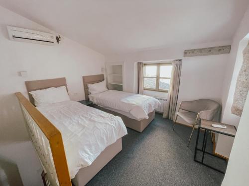 a hotel room with two beds and a window at Hotel Casa Garzotto in Rovinj