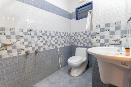a bathroom with a toilet and a sink at Marari ShangriLa Vecation Stay in Alleppey
