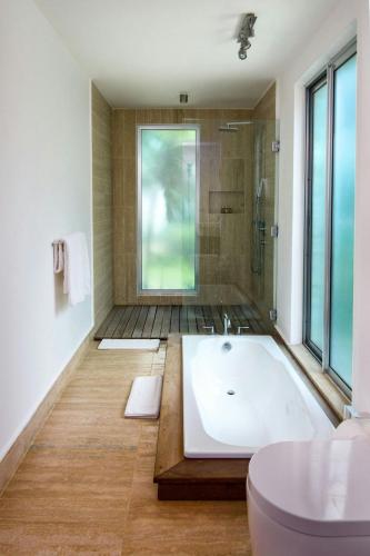 a bathroom with a large tub and a shower at The Ocean Club, a Luxury Collection Resort, Costa Norte in Sosúa