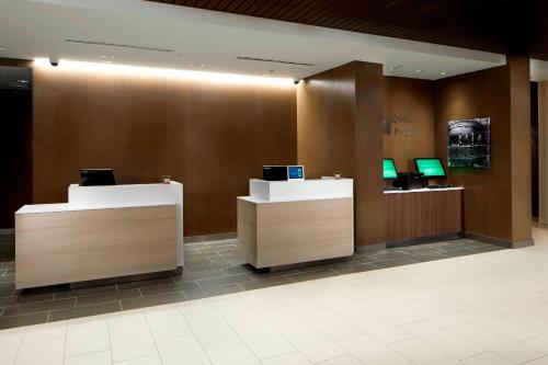 a lobby with two desks with computers on them at Courtyard Charlotte Fort Mill, SC in Fort Mill