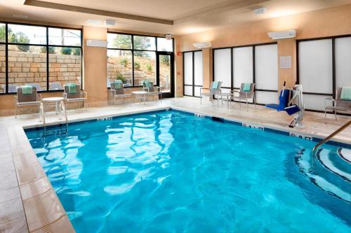 a large pool with blue water in a hotel room at Courtyard Charlotte Fort Mill, SC in Fort Mill