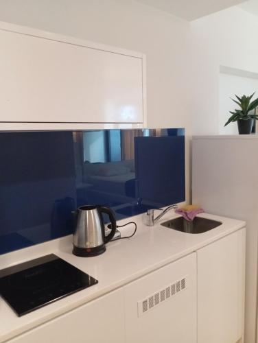 a kitchen with a tea kettle on a stove at Orbi sea view aparthotel in Angisa