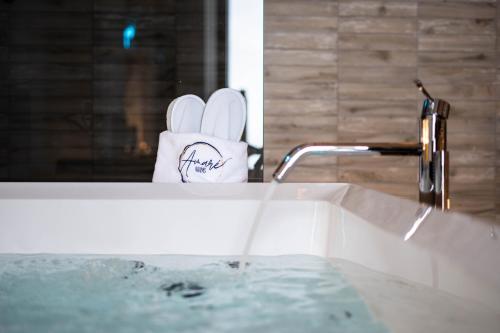 a bathroom sink with a roll of toilet paper next to it at Amarè Luxury Suite And Room Vista Mare in Bari
