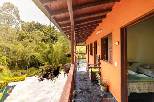 an outside view of a house with a balcony at Hotel Orillas del Pizano in Jardin