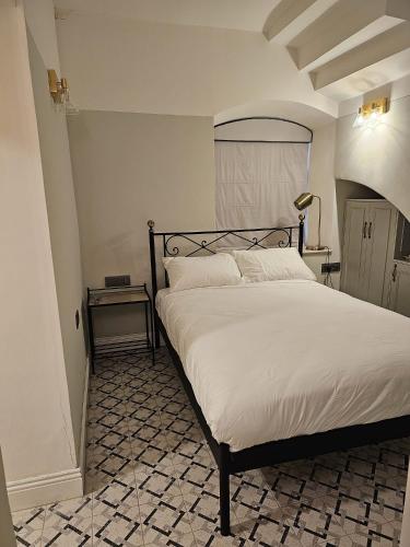a bedroom with a large bed in a room at כוהנ'ס Cohen's Boutique Hotel in Haifa