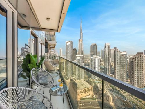 a balcony with chairs and a view of the city at Stunning 2BR with Burj View & Infinity Pool in Dubai
