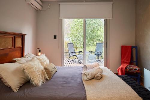 a bedroom with a large bed with stuffed animals on it at La Quebrada Potrerillos - Lodges de Montaña in Potrerillos