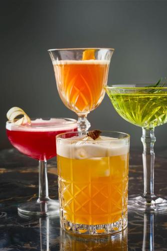 a group of three cocktails sitting on a table at Augustine, a Luxury Collection Hotel, Prague in Prague