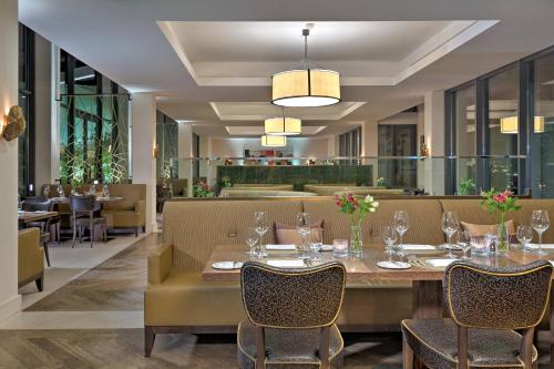 a dining room with a table and chairs at Augustine, a Luxury Collection Hotel, Prague in Prague