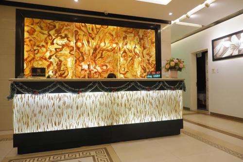 a large screen in a room with a wall at Tuong Vi Hotel in Hai Phong