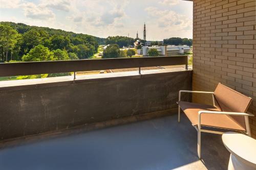 a balcony with a chair and a view of a city at Huntsville Marriott at the Space & Rocket Center in Huntsville