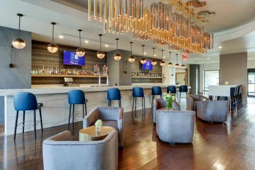 a lobby with a bar with blue chairs at Huntsville Marriott at the Space & Rocket Center in Huntsville
