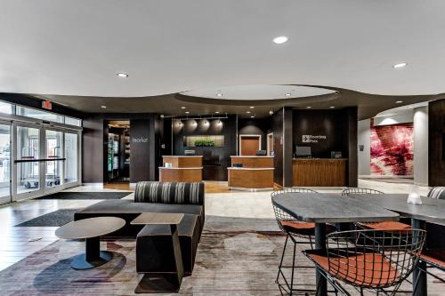 a lobby with tables and chairs in a building at Courtyard Columbus Easton in Columbus