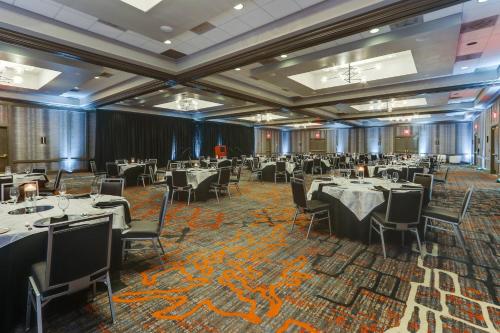 a banquet hall with tables and chairs in a room at Huntsville Marriott at the Space & Rocket Center in Huntsville